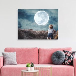 Cute Toddler saying Goodnight to the Huge Moon Canvas Print