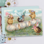 Cute Vintage Chicks in Easter Bonnets Holiday Card<br><div class="desc">Whimsical and cute vintage chicks wearing fancy floral Easter bonnets perched on eggs spelling "Easter Greetings."</div>
