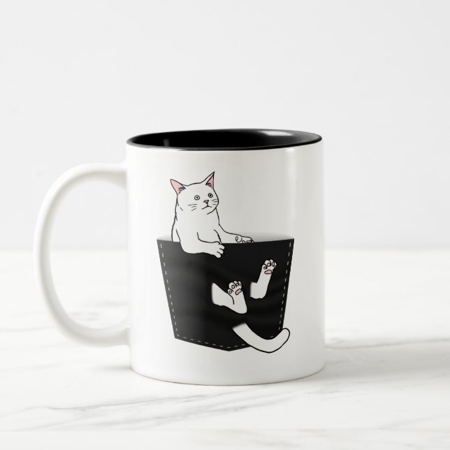 Cute White Cat Sits in Pocket Two-Tone Coffee Mug (Left)