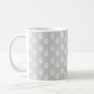 Cute white paws on silver grey coffee mug
