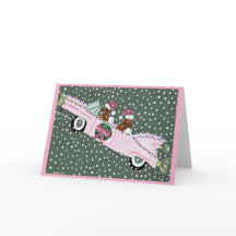 Dachshunds at Christmas in a pink convertible