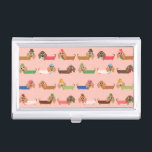 Dachshunds on Pink Business Card Holder<br><div class="desc">Dachshunds on Pink, an adorable dog design that dog lovers, especially Dachshund lovers, will find too cute to resist! Features Dachshunds in sweaters of chocolate brown, green, blue, coral, pink, and white, some wearing eye glasses, some with bows or even top hats! This cute dachshund design is available on bags,...</div>