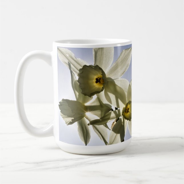 Daffodils blooming with a spring blue sky  coffee mug (Left)