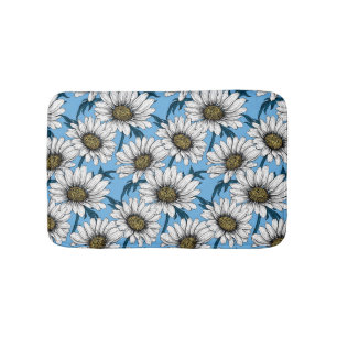 Daisies, wild flowers on blue bath mat