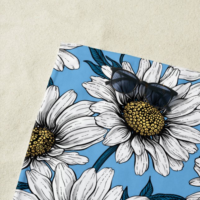 Daisies, wild flowers on blue beach towel (In Situ)