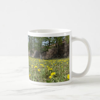 Dandelion field under the city wall coffee mug