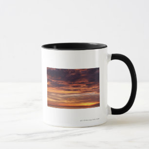 Dark clouds in orange streaked sky mug