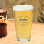 Dark Grey Stylised Wedding Groomsman Name Glass<br><div class="desc">Beer glass for the wedding groomsman that features his name printed in a dark grey,  stylised script inside a dark grey bordered oval along with wedding date. A great party supply idea for a bachelor party! Personalise your beer glass by editing and replacing name and date with your own.</div>