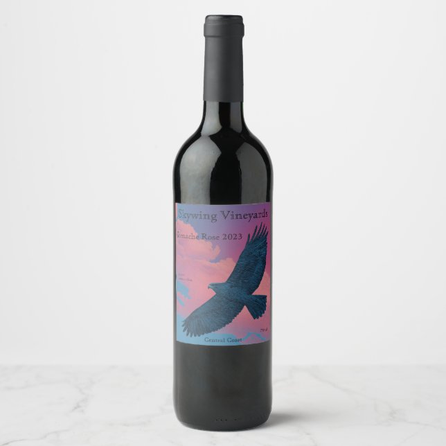 Dark hawk with wings spread across a sunset pink s wine label (Front)