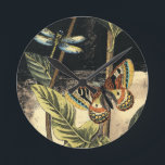 Dark Nature Scene by Vision Studio Round Clock<br><div class="desc">This dark nature scene shows a couple of butterflies and a dragonfly congregating above deep green leaves and a beautiful flower. You can almost hear the beating of wings as you study the piece. If you enjoy nature you'll enjoy this painting. Buy your copy today!</div>