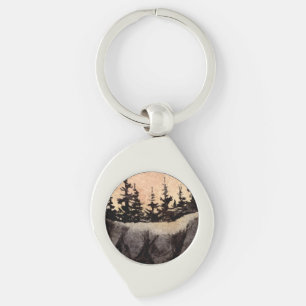 Dark pines on a cliff with a pinkish grey sky art key ring