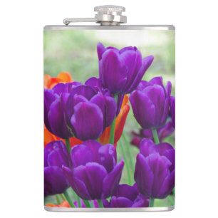 Dark purple tulips  on a sunny day in the garden  hip flask