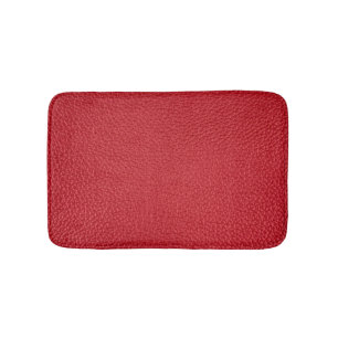 Dark red artificial leatherette closeup. bath mat