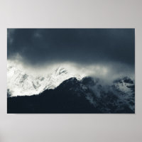 Darkness and light on snow covered mountains