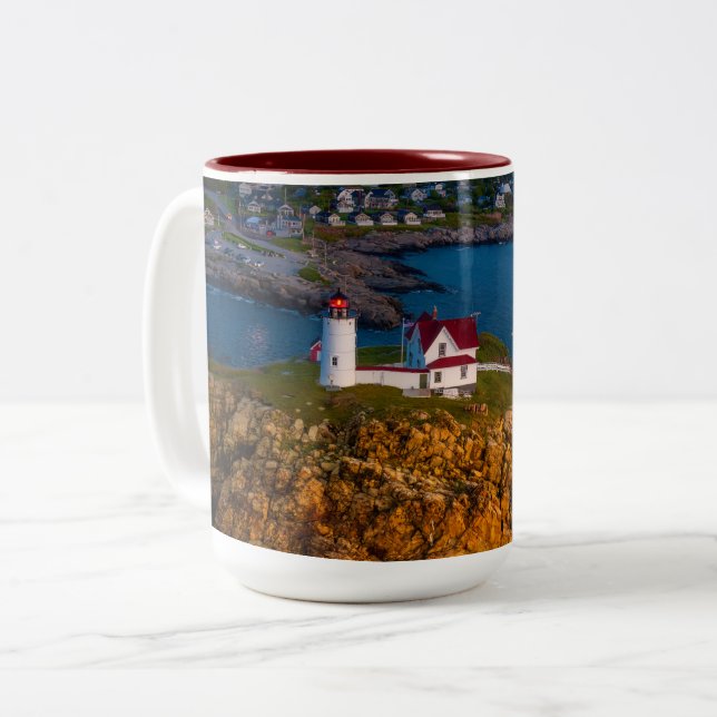 Dawns Light breaks on the Nubble's Rocky shoreline Two-Tone Coffee Mug (Front Left)