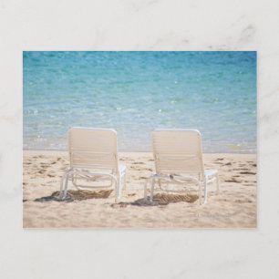 Deck chairs on sandy beach postcard