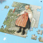 Decorating the Christmas Tree - Carl Larsson Jigsaw Puzzle<br><div class="desc">Swedish art by artist Carl Larsson. A blonde girl in traditional dress stands on a chair to decorate the Christmas tree. See store for coordinating items! About the artist: Carl Larsson was Swedish painter, illustrator, printmaker, and writer. He is now remembered mainly his watercolors of the idyllic life he enjoyed...</div>