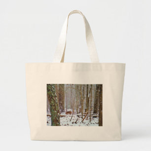 Deer in the snow, licking leg large tote bag