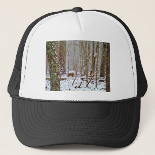 Deer in the snow, licking leg trucker hat