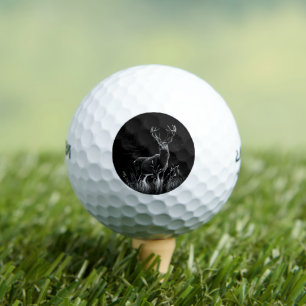 Deer with antlers framed by field and tree golf balls
