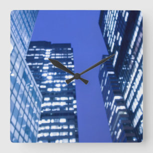 Defocused upward view of office building windows square wall clock