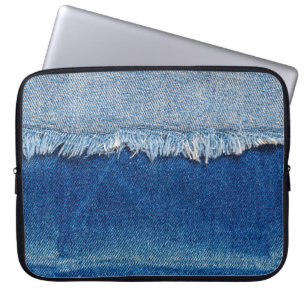 Denim jeans background. Ripped denim fabric with b Laptop Sleeve