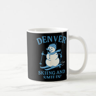 Denver colorado skiing and smilin snowman  coffee mug