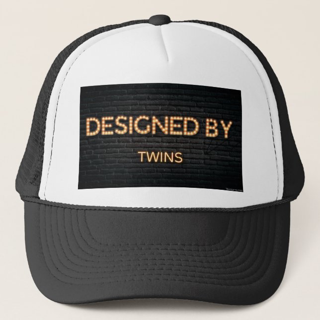 Designed by twins trucker hat for sale. (Front)