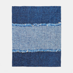 Destroyed torn denim blue jeans fabric frame on bl fleece blanket