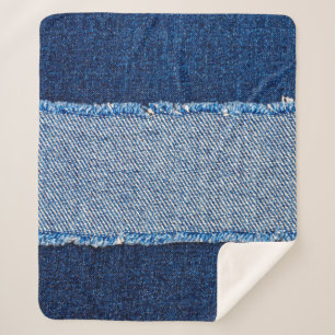 Destroyed torn denim blue jeans fabric frame on bl sherpa blanket