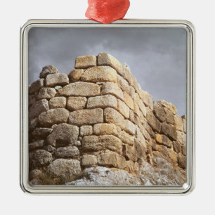 Detail of a stone wall metal tree decoration