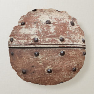 Detail of an old painted shabby door with rusty me round cushion