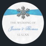 Diamante Snowflake & Blue Ribbon Winter Wedding Classic Round Sticker<br><div class="desc">The diamante snowflake & blue ribbon wedding collection is perfect for any couple planning a romantic winter wedding celebration. The design features a light silvery grey and white snowflake textured background with a diamante snowflake on top of a silky looking ribbon. The wording incorporates the same silvery grey and blue...</div>