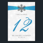 Diamante Snowflake & Blue Ribbon Winter Wedding Table Number<br><div class="desc">The diamante snowflake & blue ribbon wedding collection is perfect for any couple planning a romantic winter wedding celebration. The design features a light silvery grey and white snowflake textured background with a diamante snowflake on top of a silky looking ribbon. The wording incorporates the same silvery grey and blue...</div>