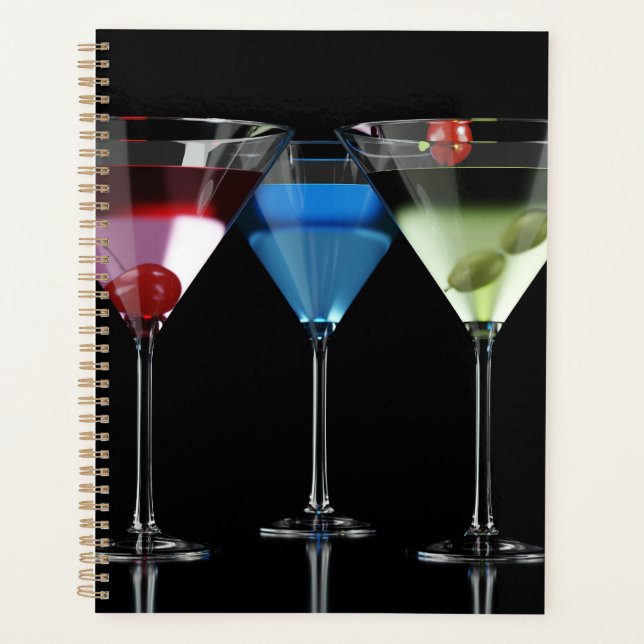 Different cocktails in martini glasses on black planner (Front)