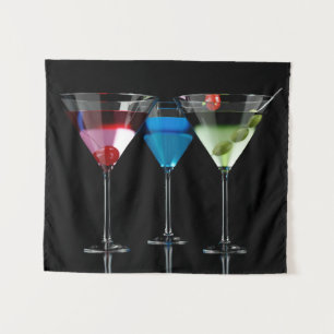 Different cocktails in martini glasses on black tapestry