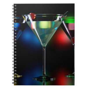 Different cocktails in martini glasses with lights notebook