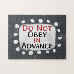 Do Not Obey In Advance Jigsaw Puzzle<br><div class="desc">Bold text reading "Do Not Obey In Advance" is centred against a grey background. The black and red text sits on a white rectangle with large textured white dots around it,  providing a playful contrast against the solid colour backdrop. This is Lesson #1 from "On Tyranny" by Timothy Snyder.</div>