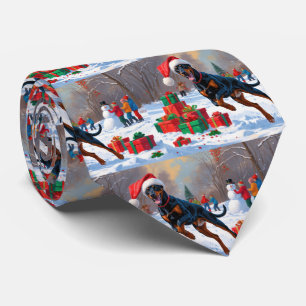 Doberman Running in Snow with Christmas Hat Tie