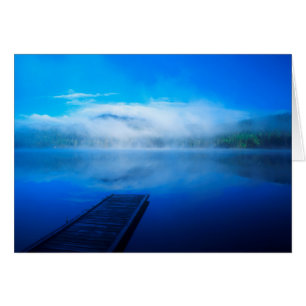 Dock on calm misty lake, California