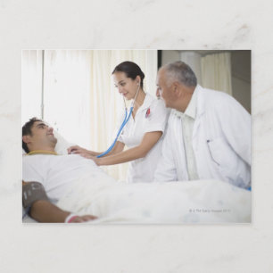 Doctor and nurse tending to patient postcard