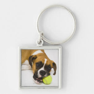 Dog biting tennis ball key ring