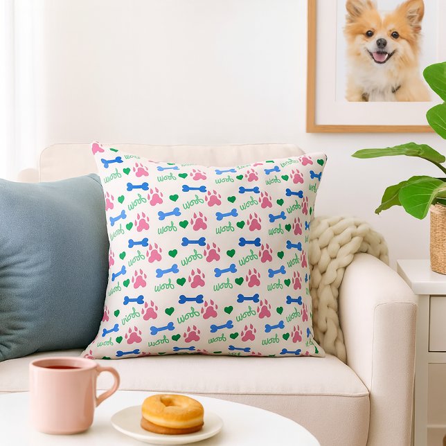 Dog Bone Woof Pink Blue Green Pattern Cushion (A throw pillow with a pattern of pink dog paws, blue bones and green woofs.)