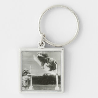 Dogs jumping over miniature high jump bar key ring