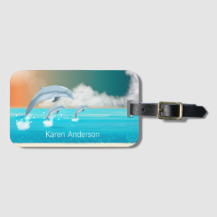 dolphins breaching in the ocean luggage tag