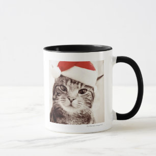 Domestic tabby cat wearing red Christmas hat Mug