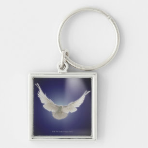 Dove flying through beam of light key ring
