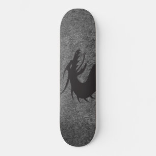 Dragon silhouette, with grass in the background, skateboard