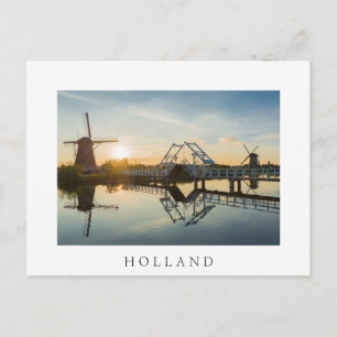 Drawbridge and windmills at sunset in Holland Postcard