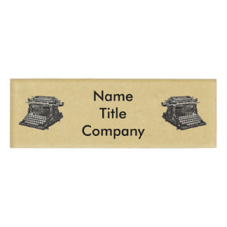 Drawing of black Old Time Typewriters on Tan Name Tag